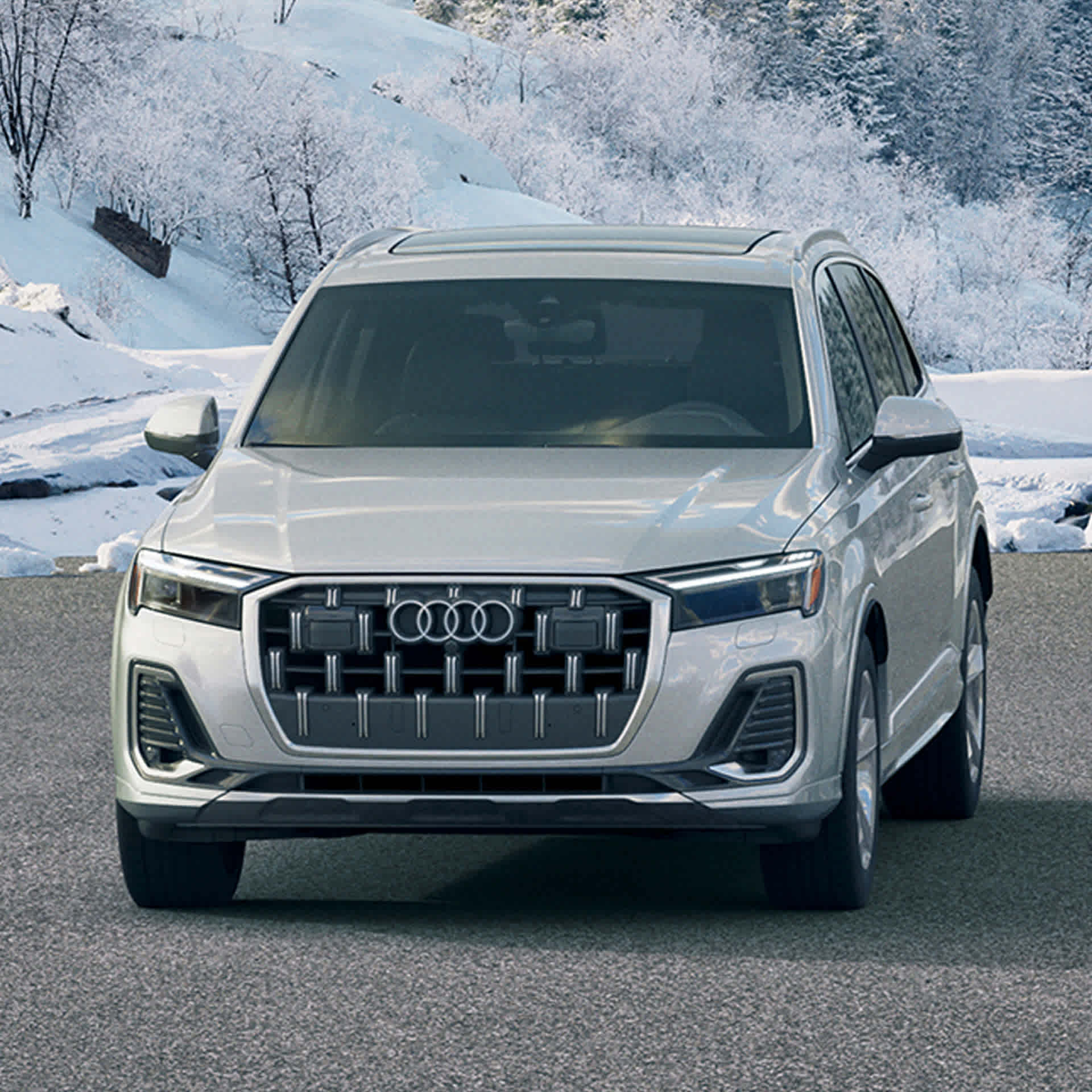 Front profile view of an Audi Q7 parked in a snowy Colorado Springs.